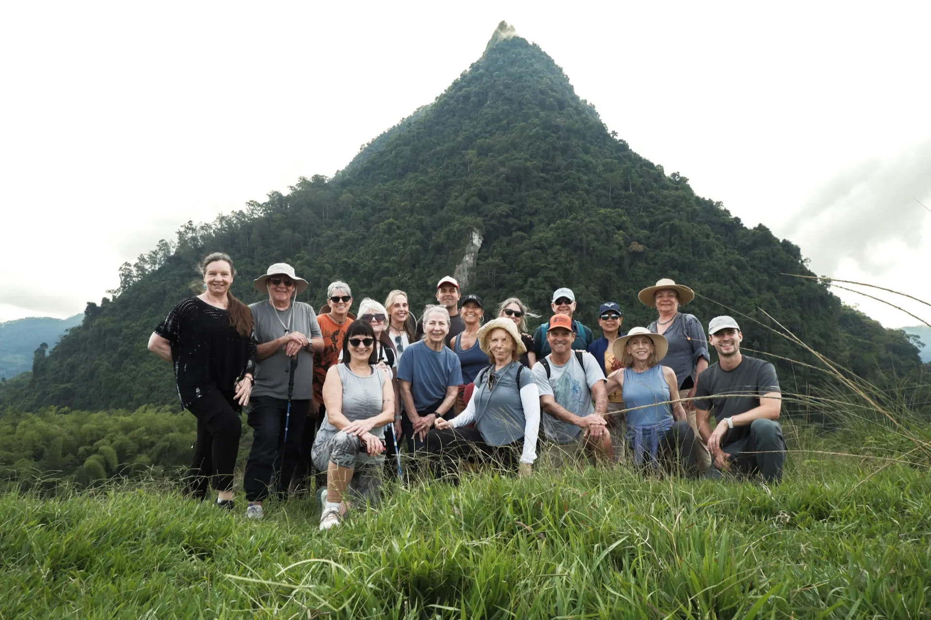 Group yoga session in front of Cerro Tusa pyramid mountain